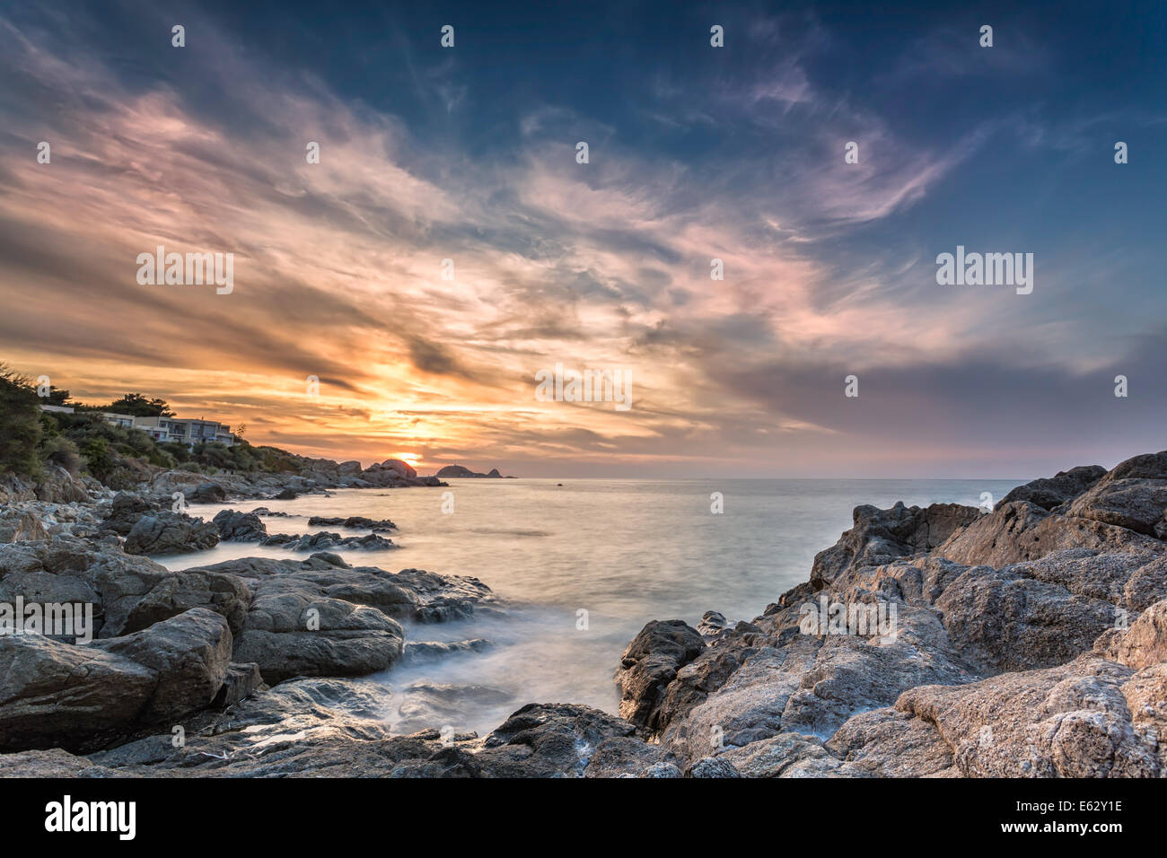 Sunset over Ile Rousse in the Balagne region of Corsica with rocks in ...