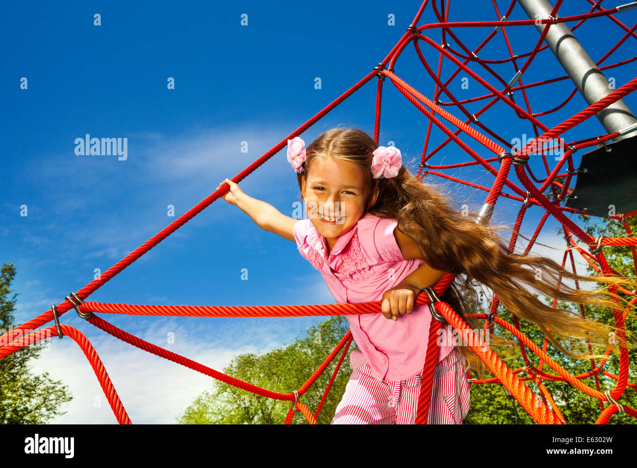 Girl Standing With Rope Smiling girl with long hair stands on red rope Stock Photo - Alamy