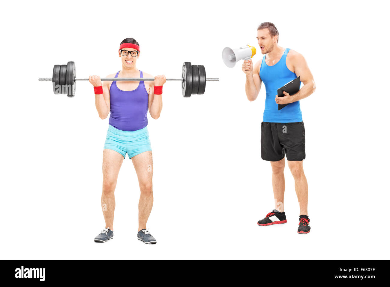 Fitness coach shouting at a nerdy guy through megaphone Stock Photo