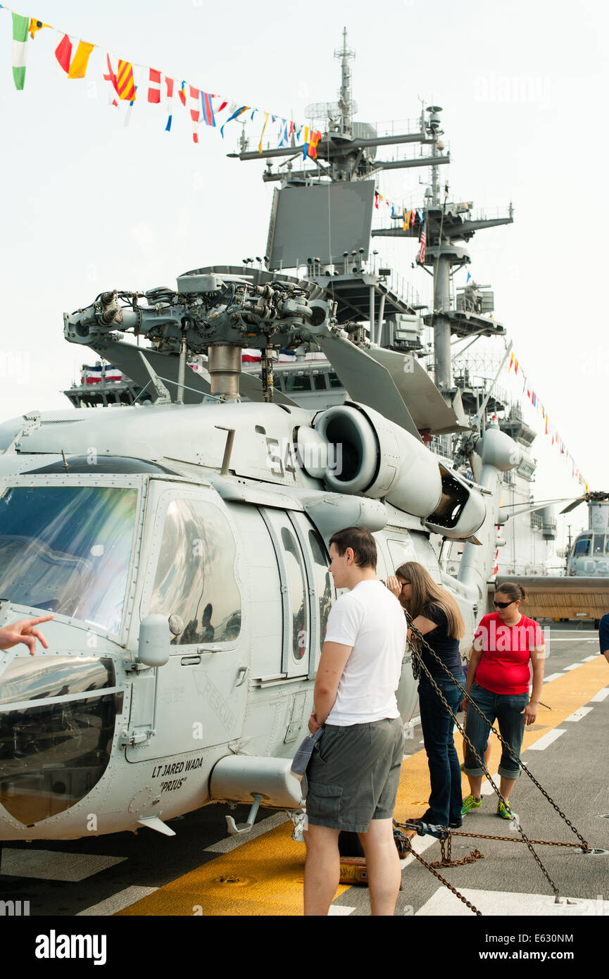 People admire a Sikorsky SH-60 Seahawk helicopter. Stock Photo