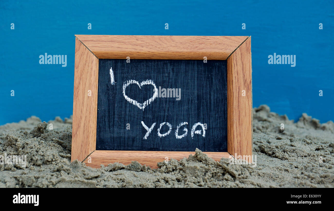I love yoga written on a chalkboard at the beach Stock Photo - Alamy