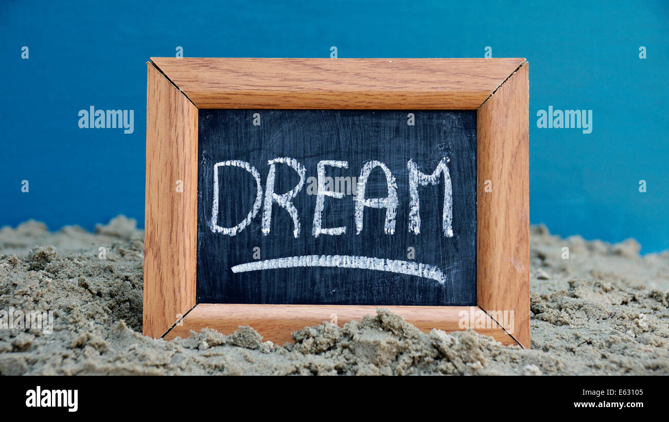 Dream written on a chalkboard at the beach Stock Photo - Alamy