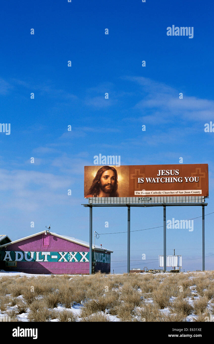 RELIGIOUS BILLBOARD SIGN JESUS IS WATCHING YOU NEXT TO ADULT X RATED THEATER Stock Photo