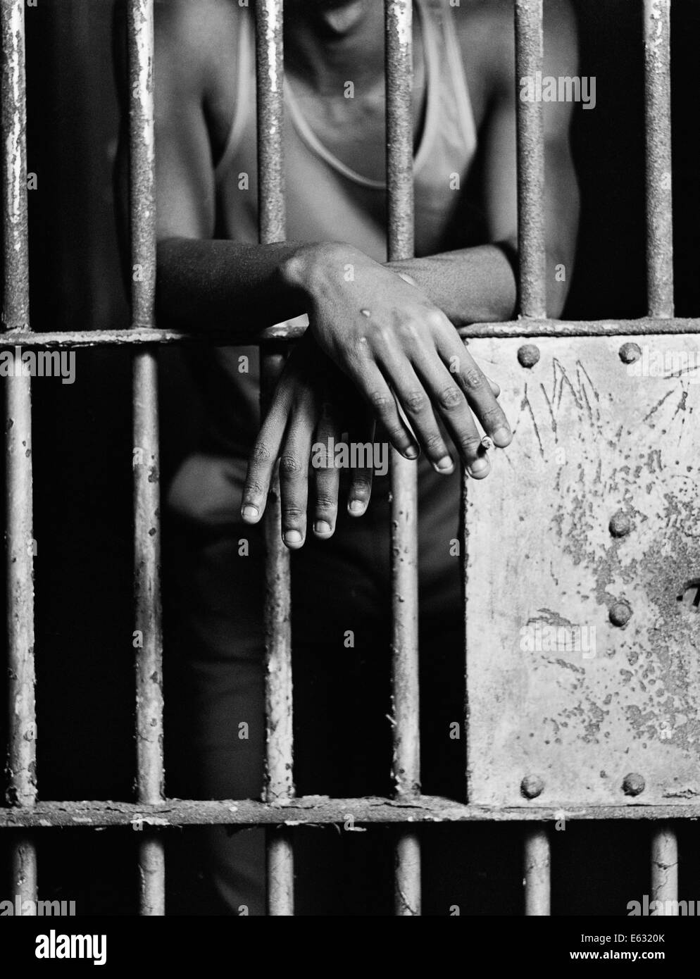 Hands through prison bars Black and White Stock Photos & Images Alamy