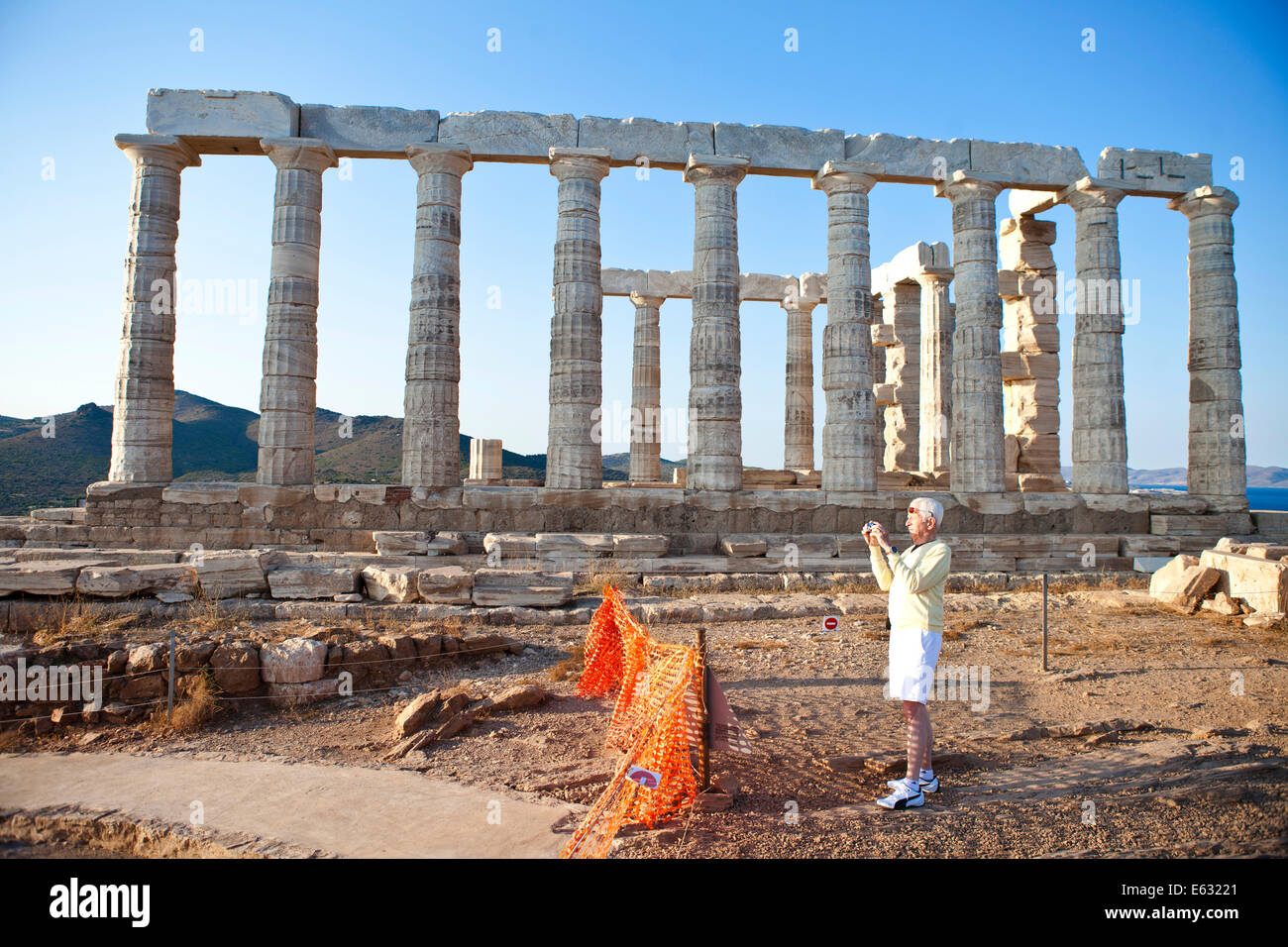 Sounion Poseidon Temple and a Tourist Stock Photo
