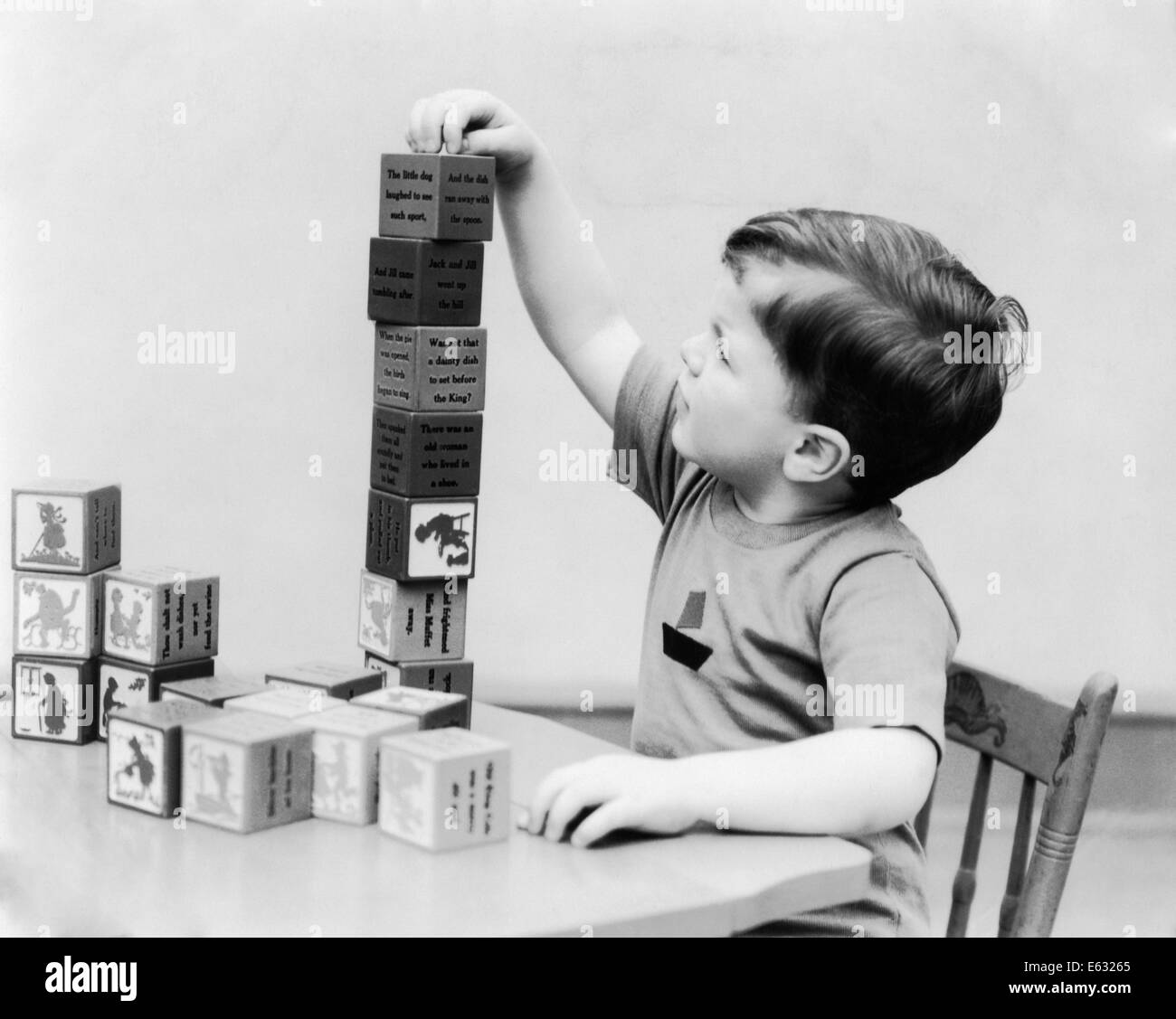 1930s BOY STACKING PLAYING WITH NURSERY RHYME THEME BUILDING BLOCKS