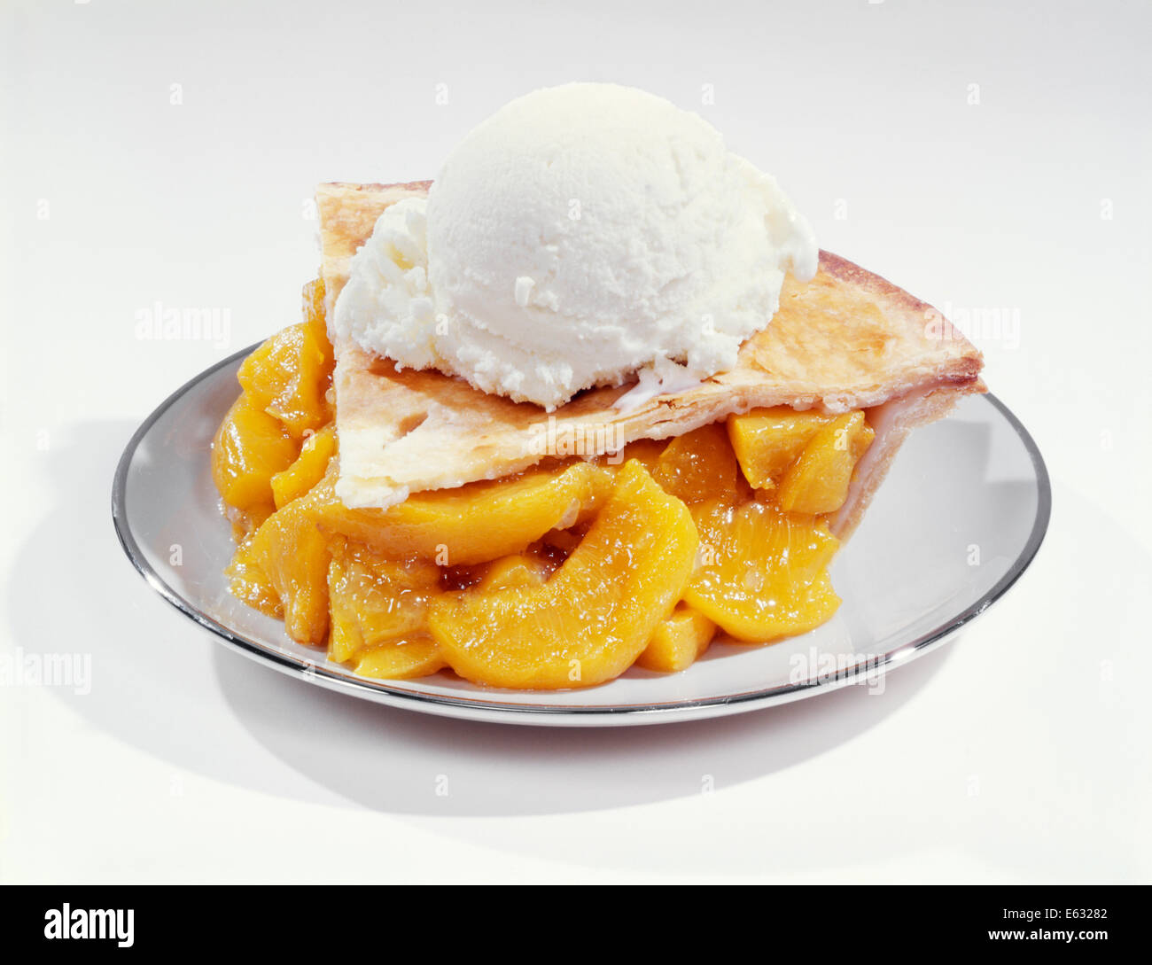 1950s 1960s SLICE OF PEACH PIE ALA MODE WITH VANILLA ICE CREAM Stock