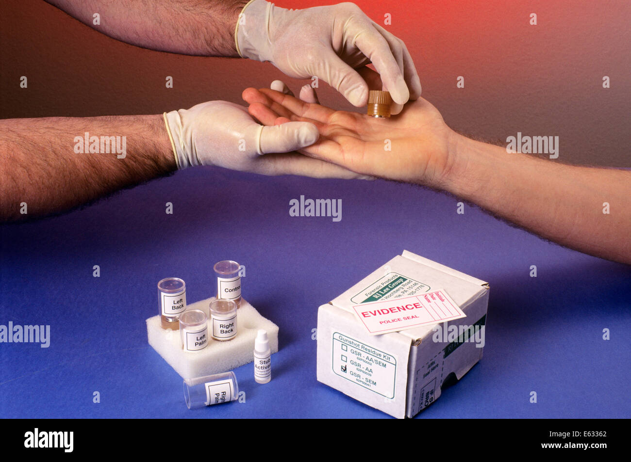 1990s HANDS PERFORMING A GUNSHOT RESIDUE TESTING PROCEDURE Stock Photo