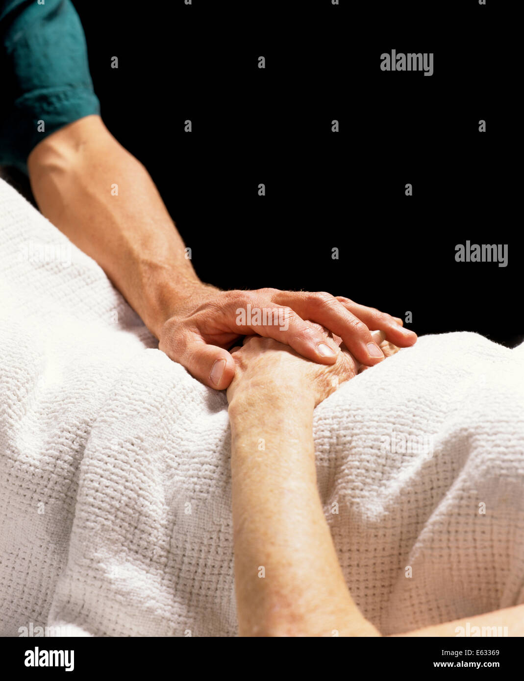 1990s CLOSE-UP OF PHYSICIAN’S HAND RESTING ON HANDS OF ELDERLY PERSON ...