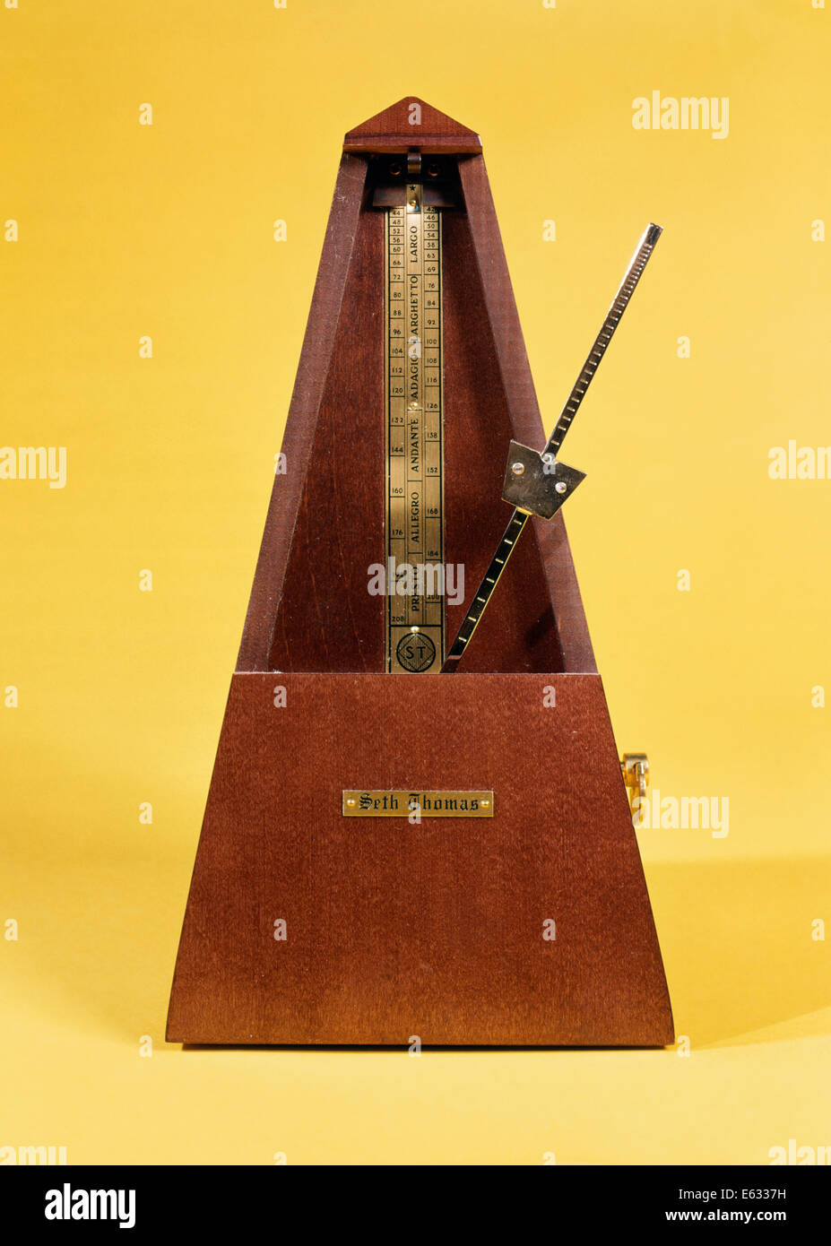WOODEN AND BRASS METRONOME Stock Photo