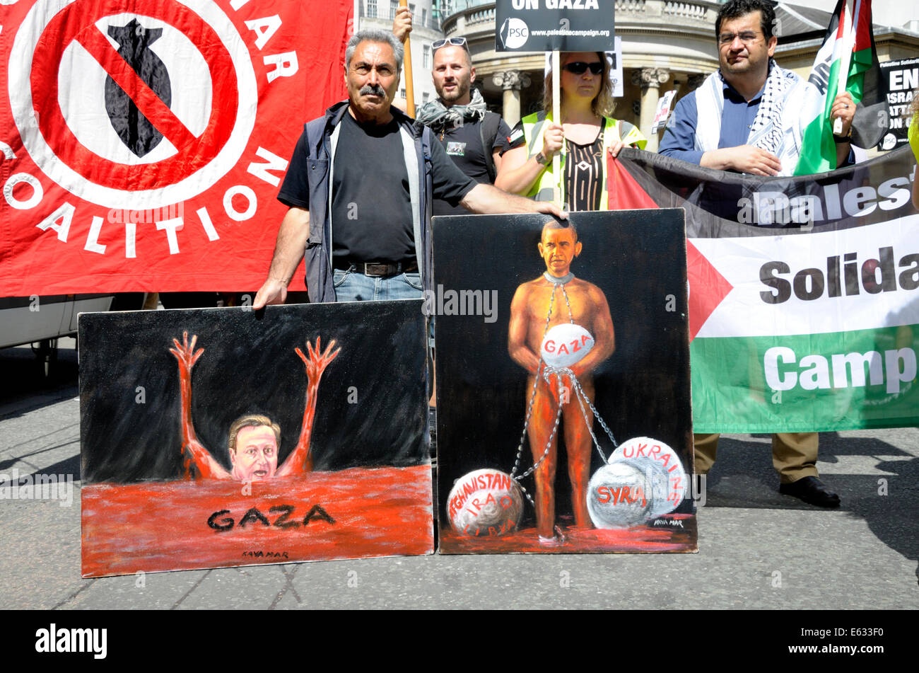 Kaya Mar - Turkish political cartoonist - with two of his satirical paintings at the March for Gaza, London, August 9th 2014 Stock Photo