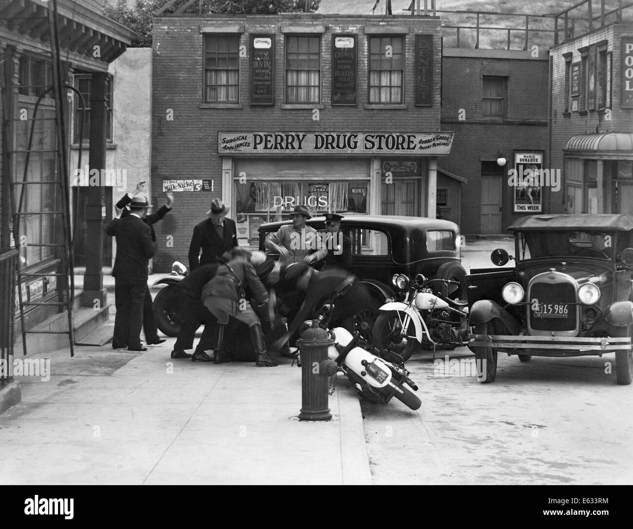 1920s 1930s MOVIE STILL OF CLASH BETWEEN BOOTLEGGERS AND GANGSTERS AND POLICE ON CITY STREET Stock Photo