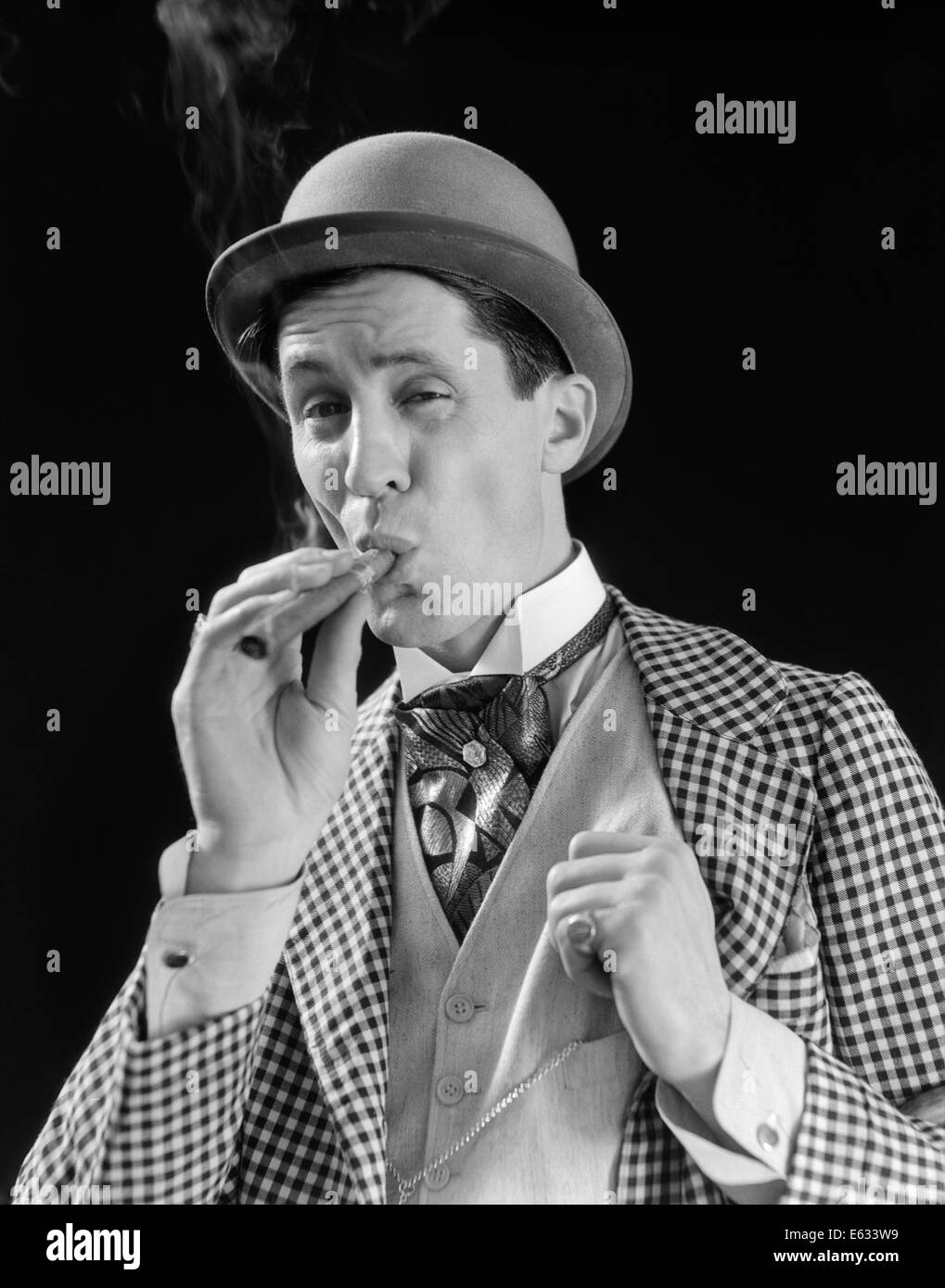 1910s 1920s CHARACTER MAN INHALING CIGAR CON MAN BOWLER HAT FANCY SUIT CRAVAT Stock Photo