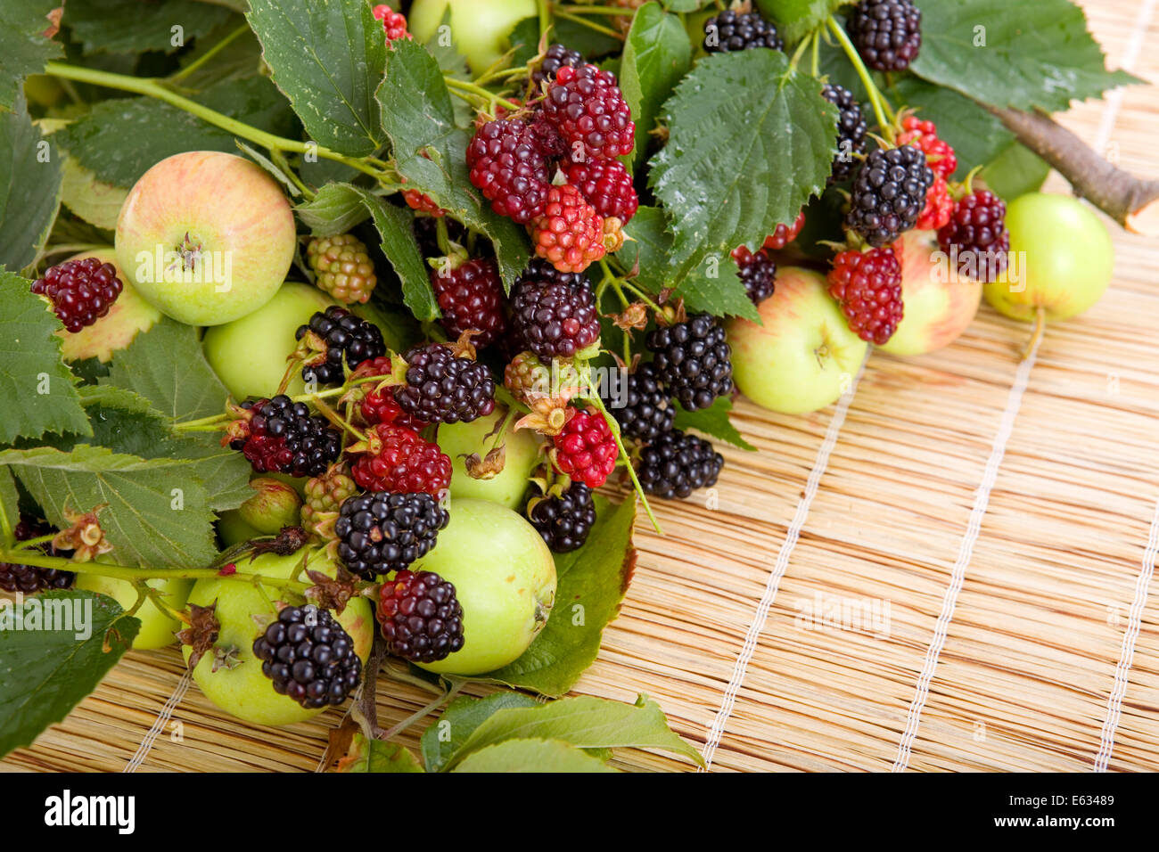 Apple Size Raspberry apples and raspberries on a wooden table Stock Photo - Alamy