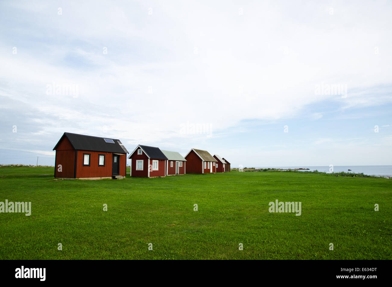Fishermens traditional red cabins at an old fishing village by the coast of the swedish island Oland Stock Photo