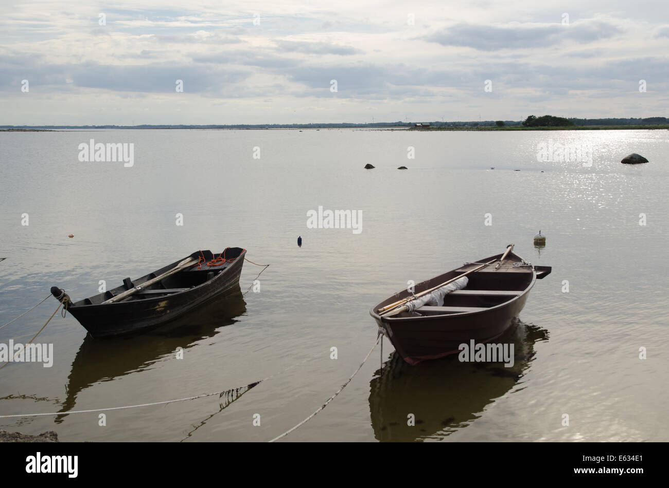 Two old wooden rowing boats tied up at the coast Stock Photo - Alamy