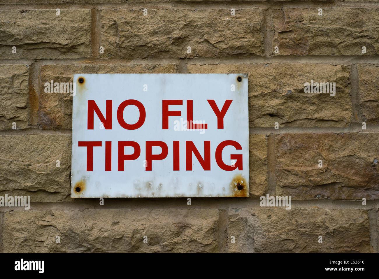 No Fly Tipping sign on wall Stock Photo