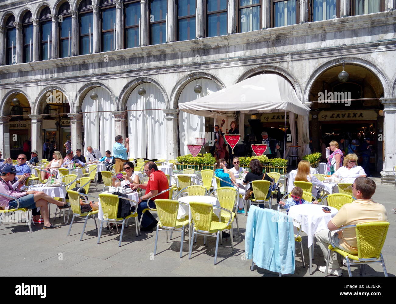 Tourists chilling at a cafe in San Marco Square in Venice, Italy Stock Photo