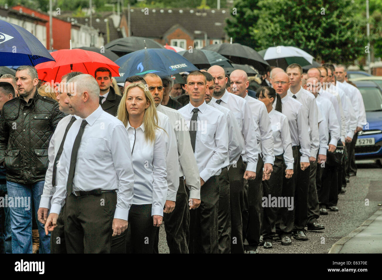 Former republican colleagues line the cortege during the funeral of IRA veteran Tony Catney, Belfast, Northern Ireland. Stock Photo