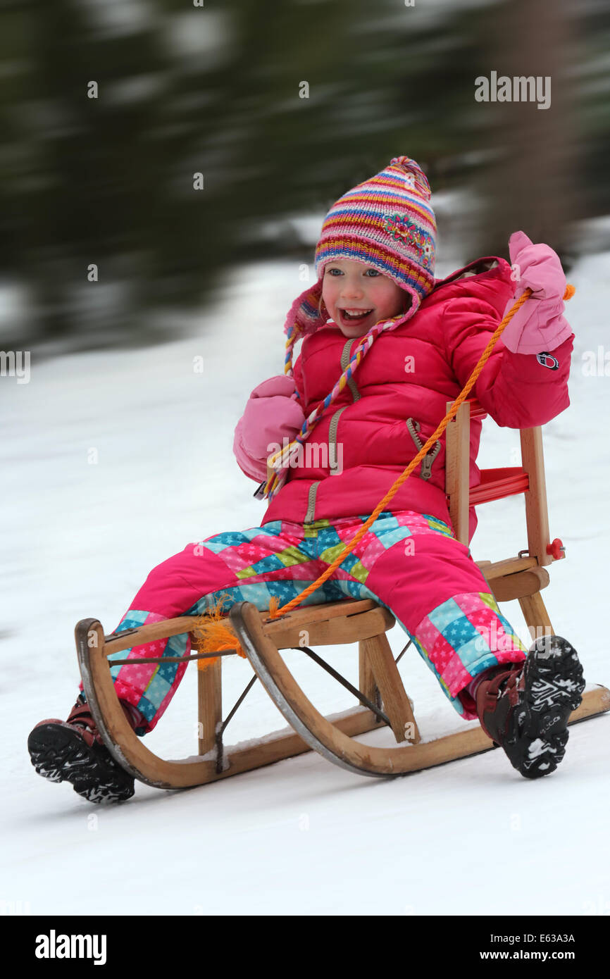 Young girl (4 years) rides on a sled in Dortmund, Germany Stock Photo