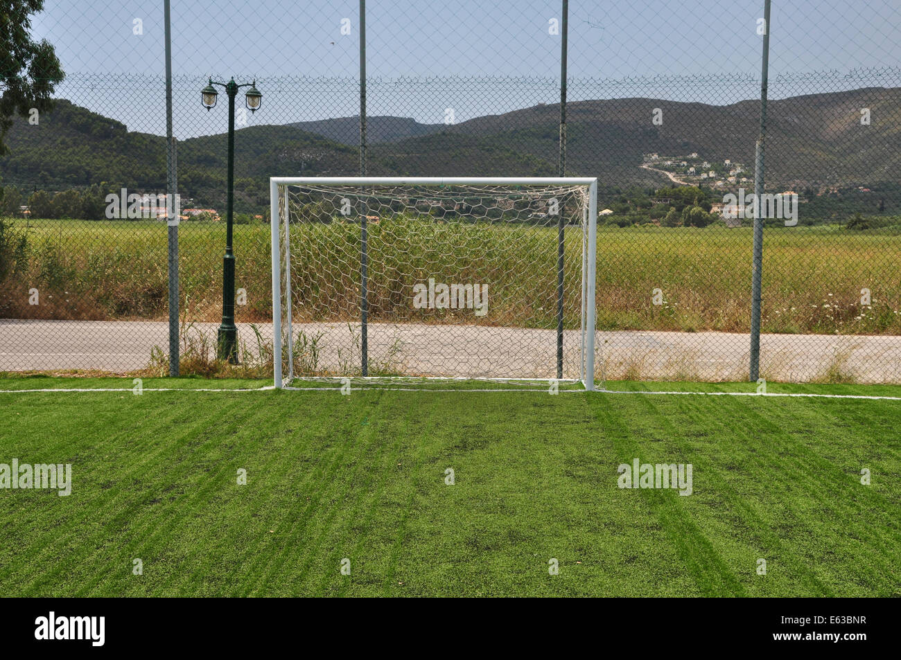 Soccer goalpost and net in empty sports field. Stock Photo