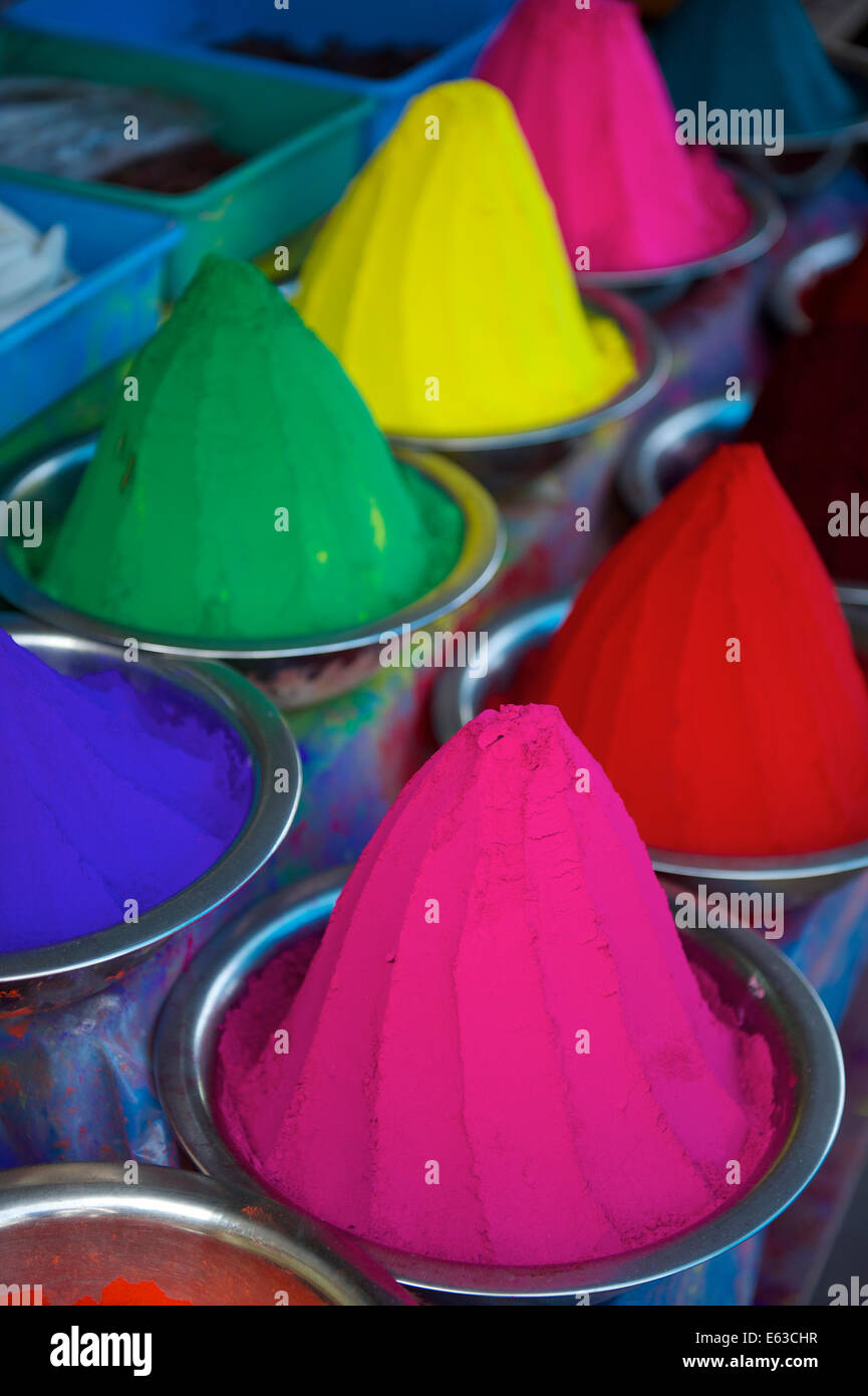 Colorful piles of Indian bindi powder dye at outdoor local market in India blue, yellow, red, green, pink, and purple Stock Photo