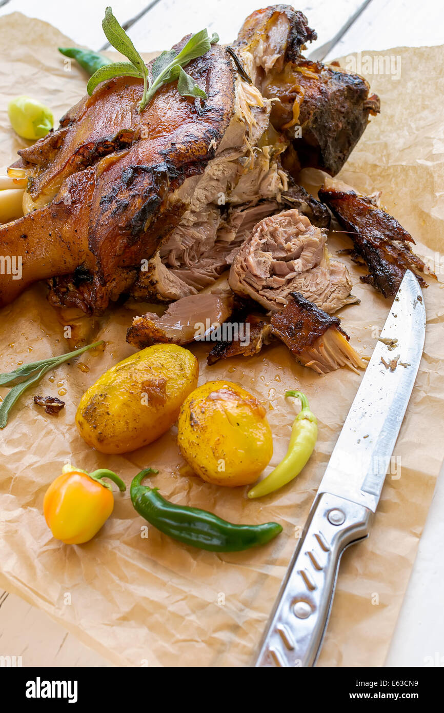 Knuckle baked with a toasted skin, potatoes and chillies Stock Photo
