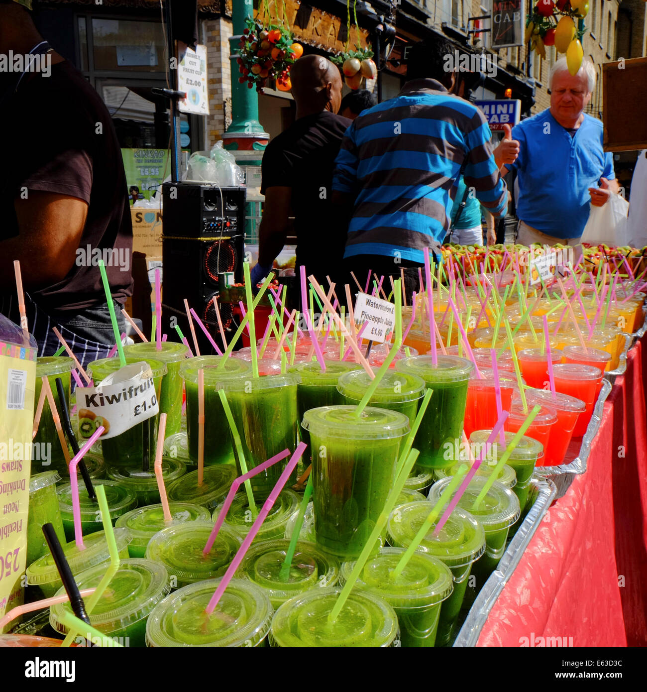 cold fruit smoothies fro sale on market stall in Shorditch, London Stock Photo