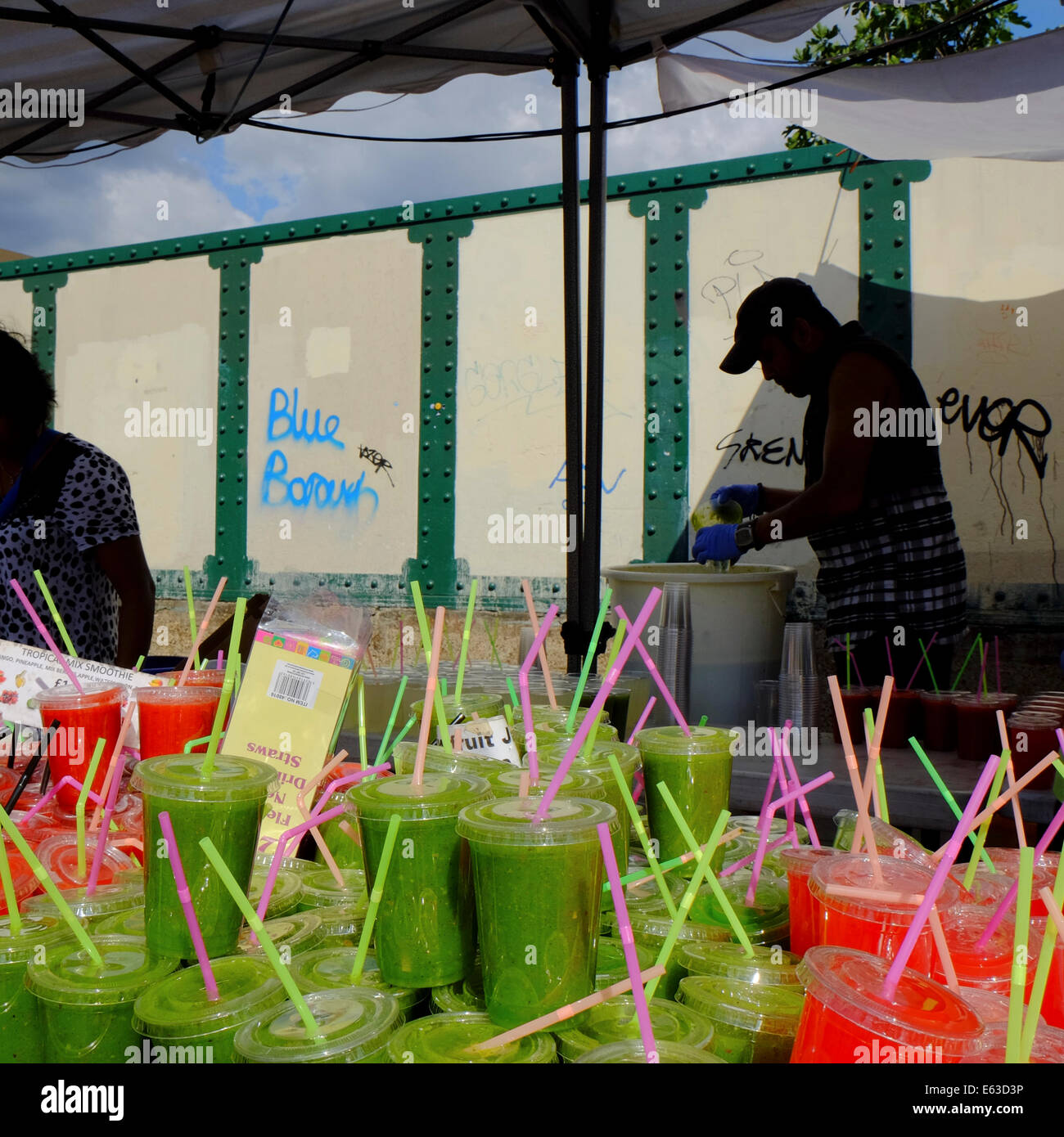 cold fruit smoothies fro sale on market stall in Shorditch, London