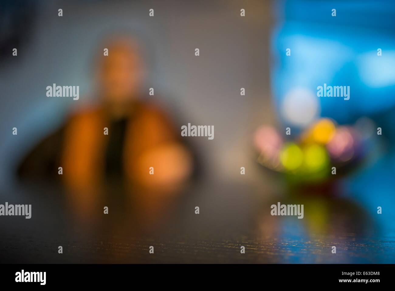 Portrait of woman with a fruit bowl, blurred effect. Stock Photo
