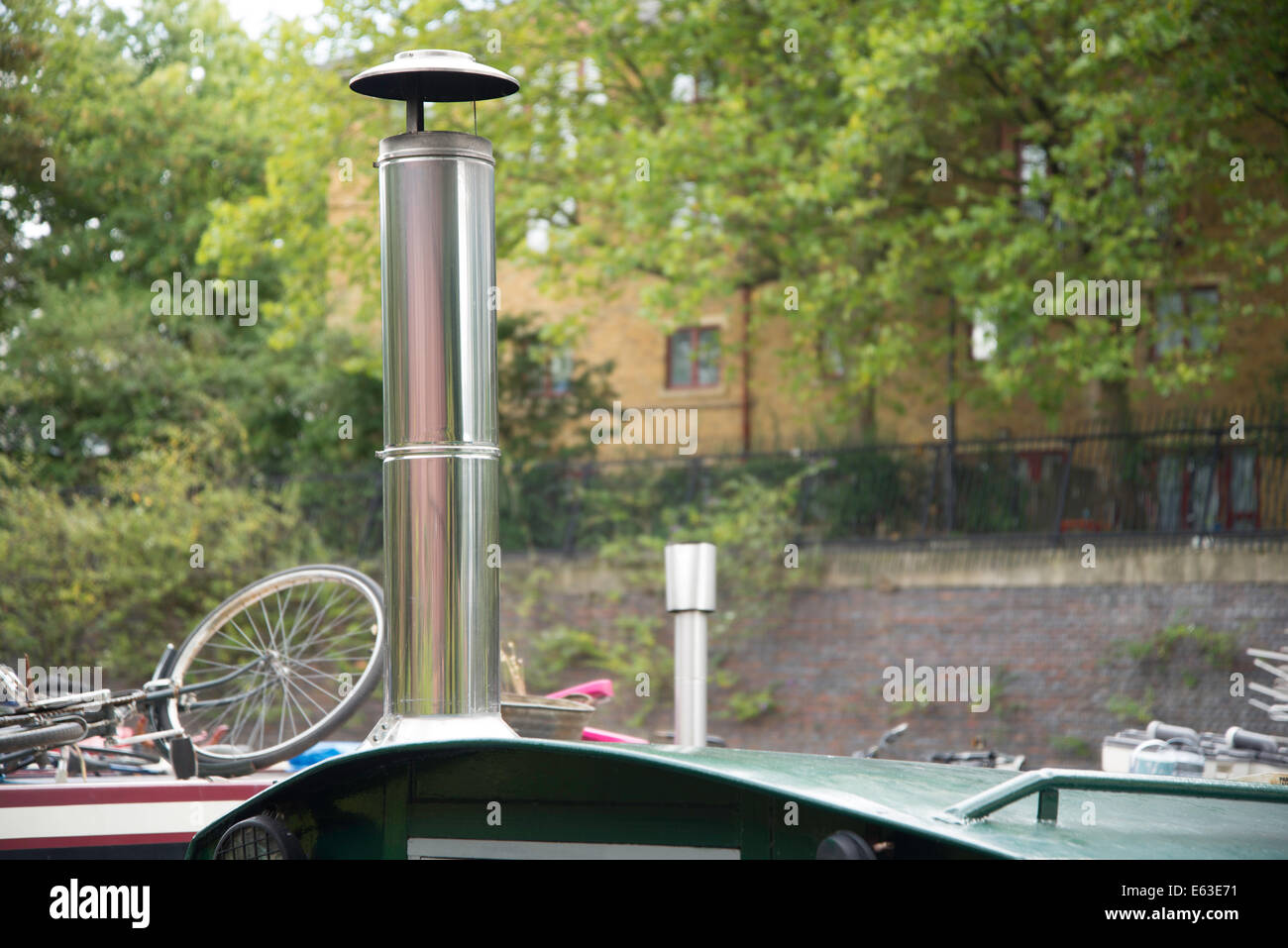 2014, Close up of chrome chimney with pink reflection on a canal boat on Regents Canal, London Stock Photo