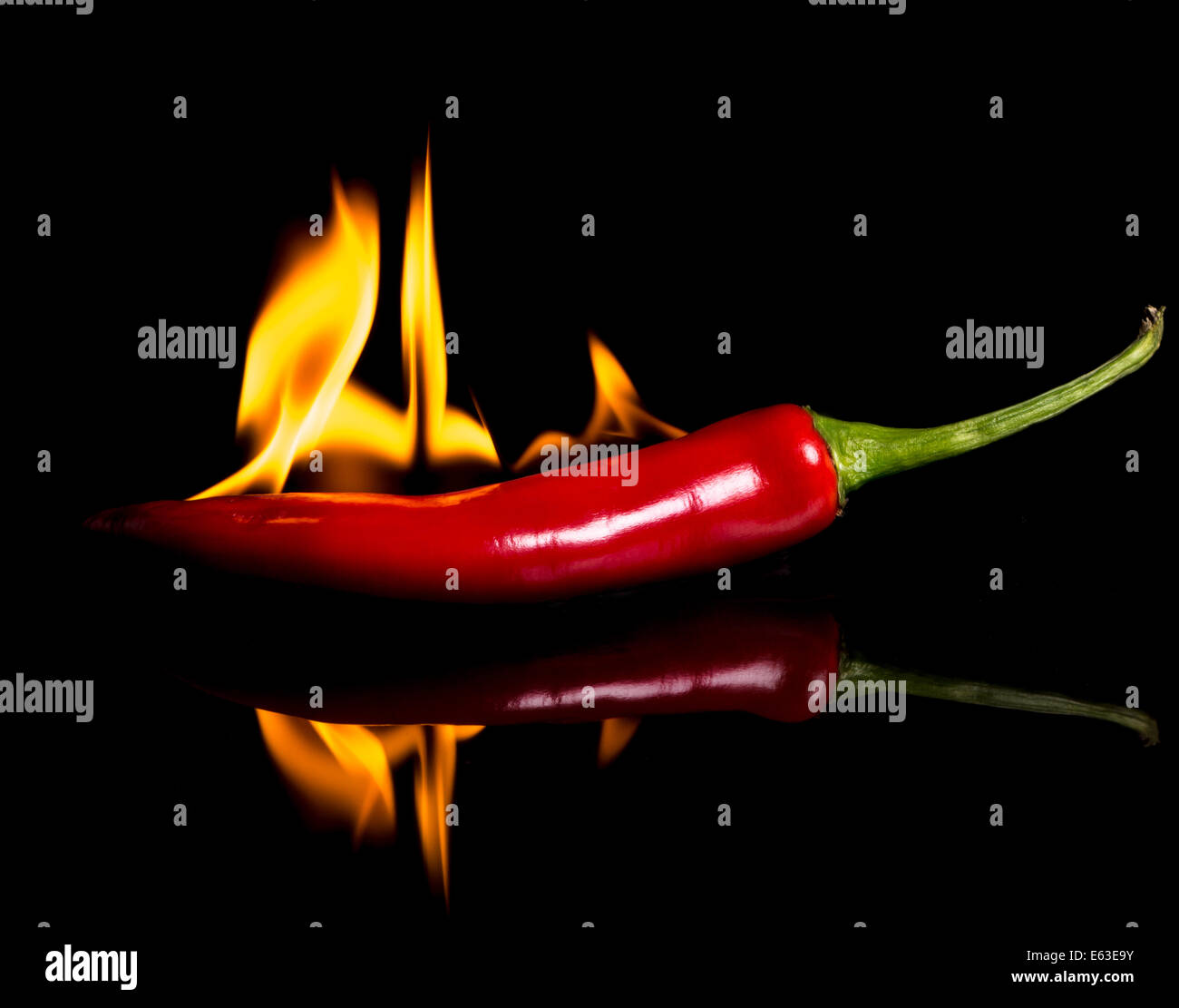 hot pepper - chili and flames on a black background. low key Stock Photo