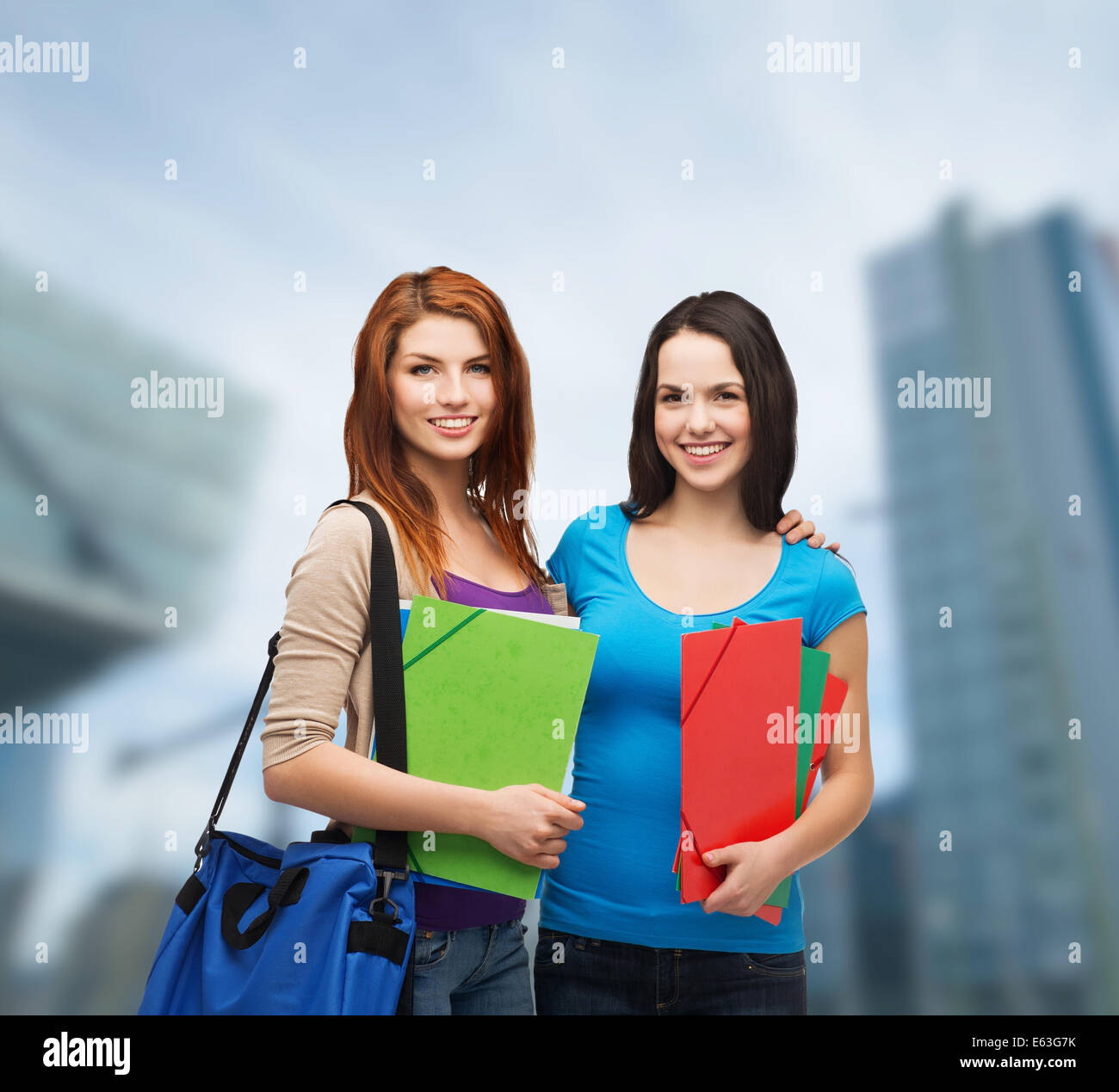 two smiling students with bag and folders Stock Photo - Alamy
