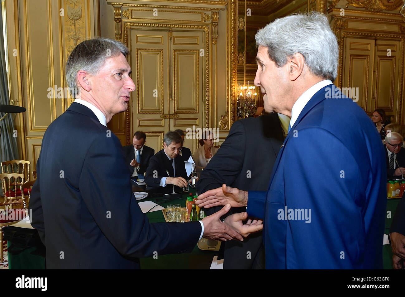 U.S. Secretary of State John Kerry greets British Foreign Secretary Philip Hammond -- their first face-to-face meeting since Hammond's recent appointment -- at the Quai d'Orsay in Paris, France, on July 26, 2014, before a meeting with a series of internat Stock Photo