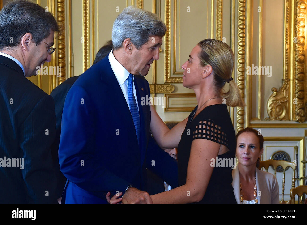 U.S. Secretary of State John Kerry greets Italian Foreign Minister Federica Mogherini at the Quai d'Orsay in Paris, France, on July 26, 2014, before a meeting with a series of international partners seeking a cease-fire in the fighting between Israel and Stock Photo