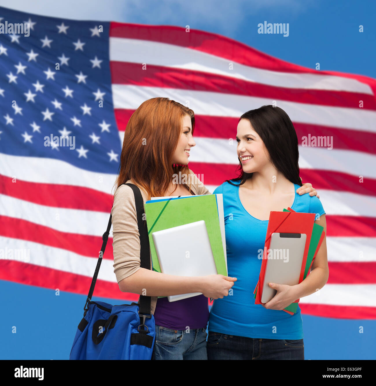 two smiling students with bag and folders Stock Photo - Alamy