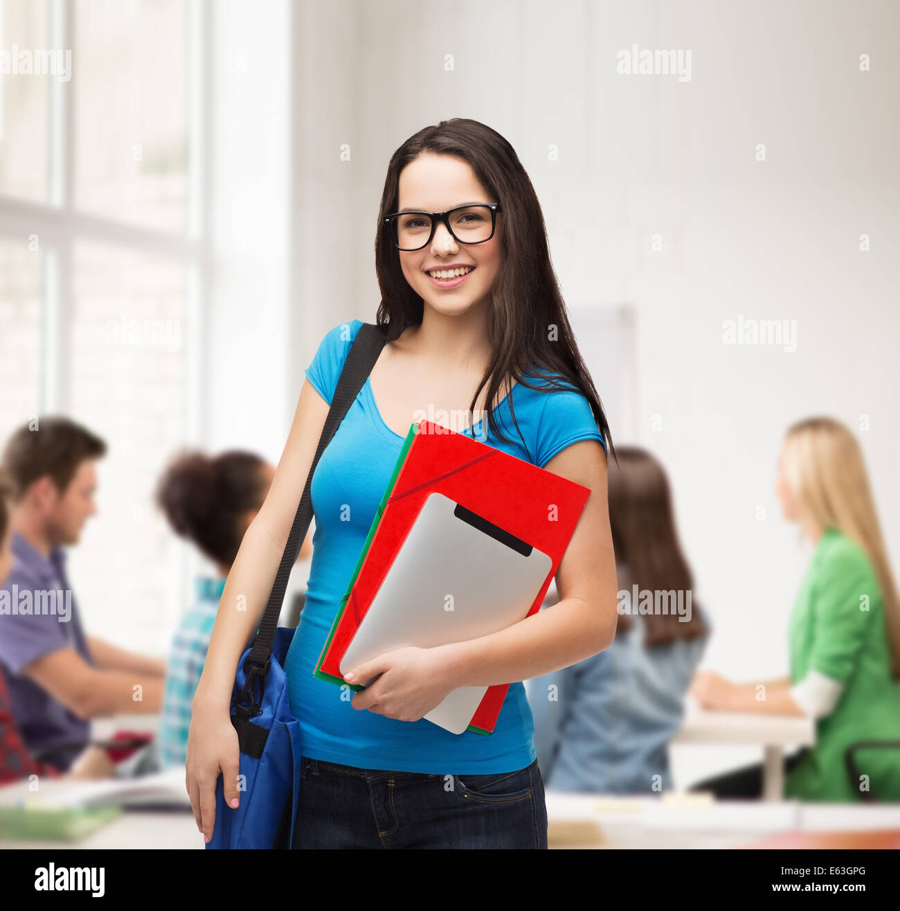 smiling student with bag, folders and tablet pc Stock Photo - Alamy