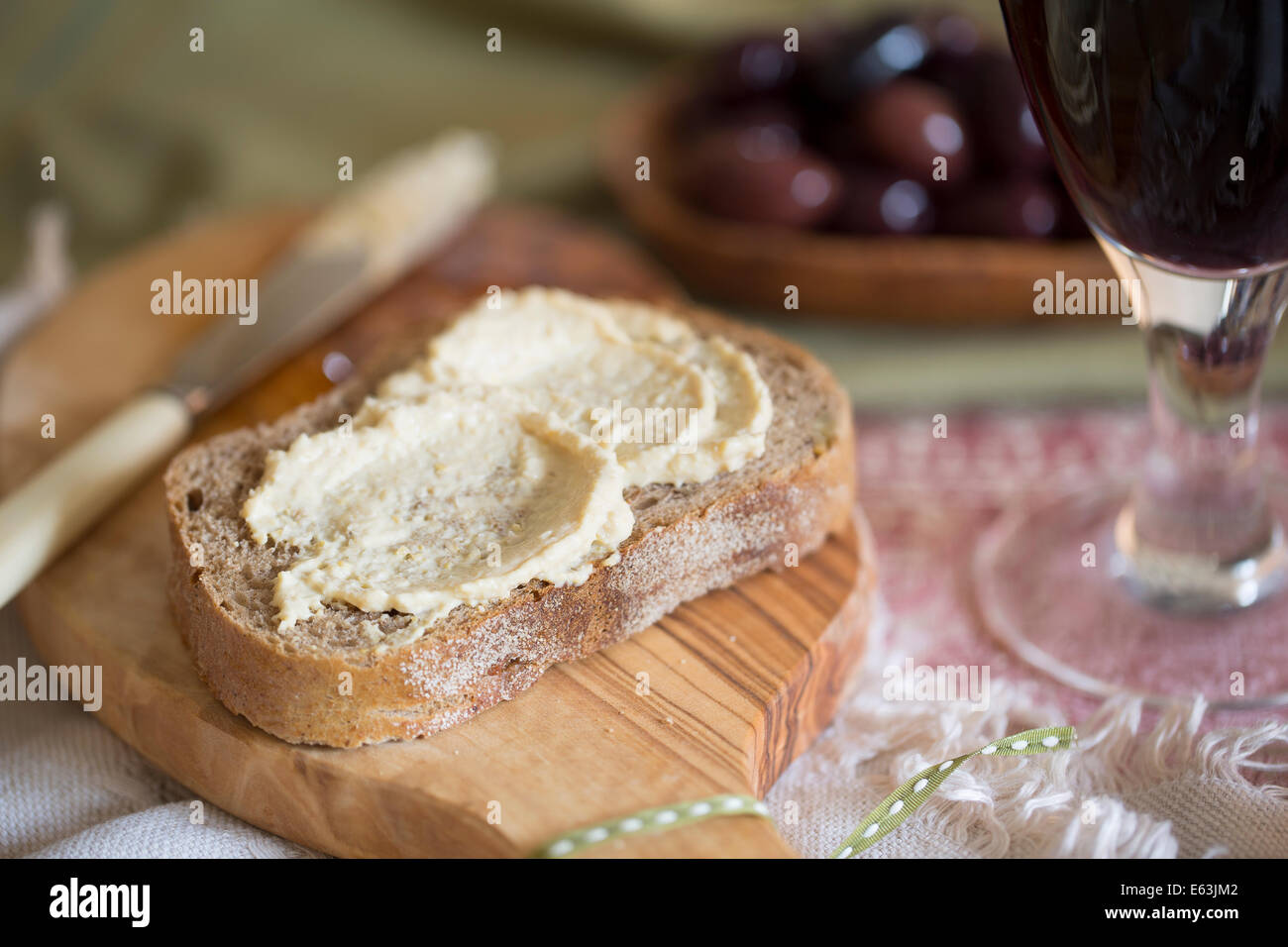 Creamy hummus spread on healthy whole wheat toast Stock Photo Alamy