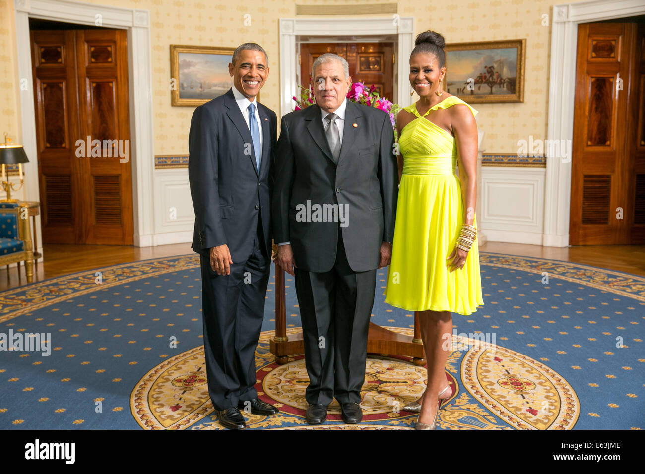 President Barack Obama and First Lady Michelle Obama greet His Excellency Ibrahim Roshdy Mahlab, Prime Minister of the Arab Republic of Egypt, in the Blue Room during a U.S.-Africa Leaders Summit dinner at the White House, Aug. 5, 2014. (Official White Ho Stock Photo