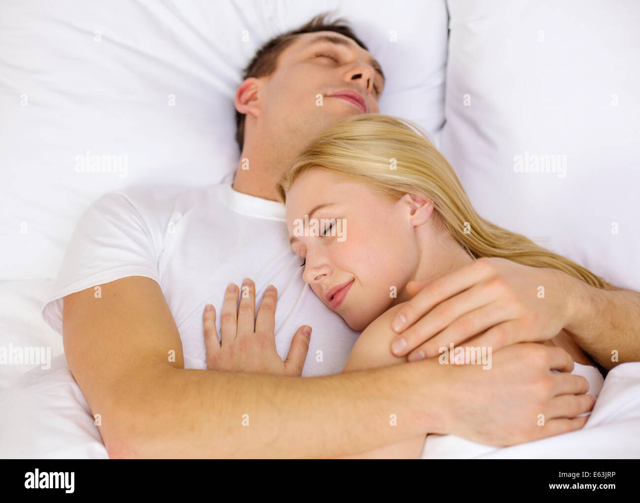 happy couple sleeping in bed Stock Photo - Alamy