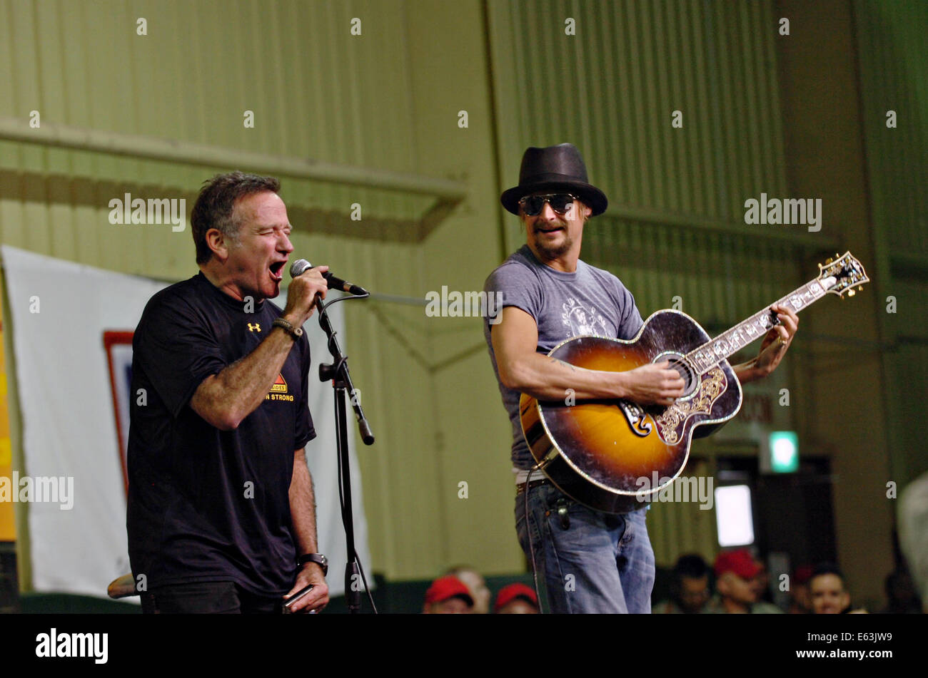 Actor and comedian Robin Williams, left, and rock musician Kid Rock perform for American troops at contingency operating base Speicher during the 2007 USO Christmas Tour December 19, 2007 in Tikrit, Iraq. Stock Photo
