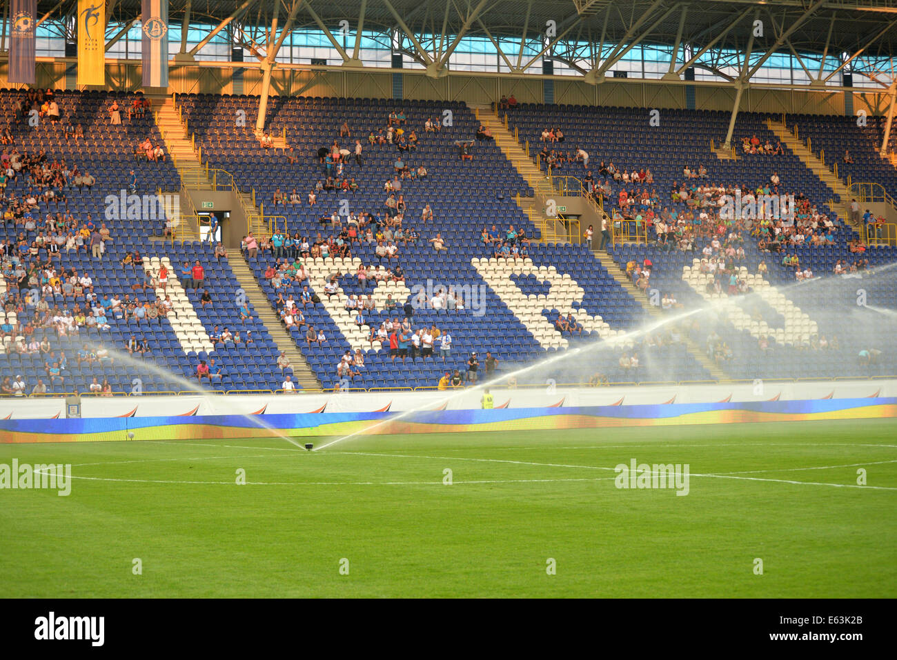 Watering the field during the match between FC Dnipro and FC Karpaty at Stadium Dnipro-Arena, Ukraine Stock Photo