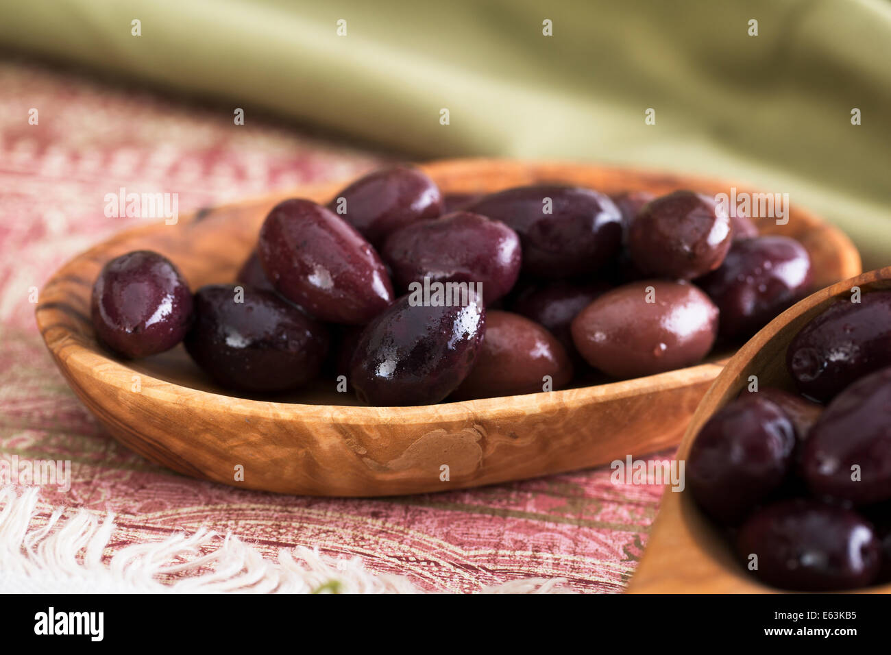 Kalamata olives in a small wooden bowl Stock Photo
