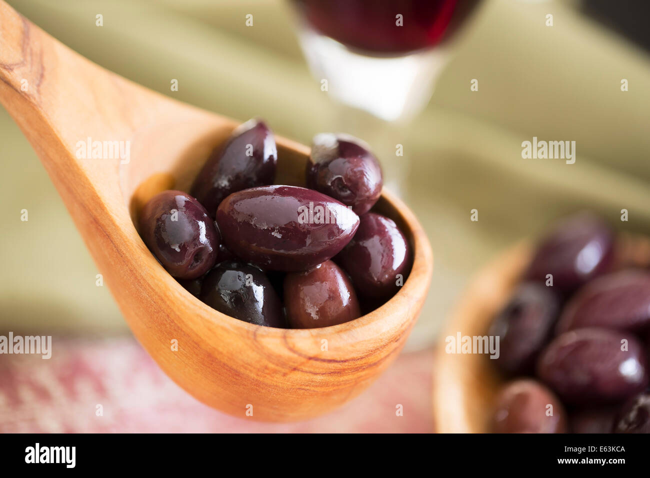 Wooden scoop of kalamata olives. Stock Photo