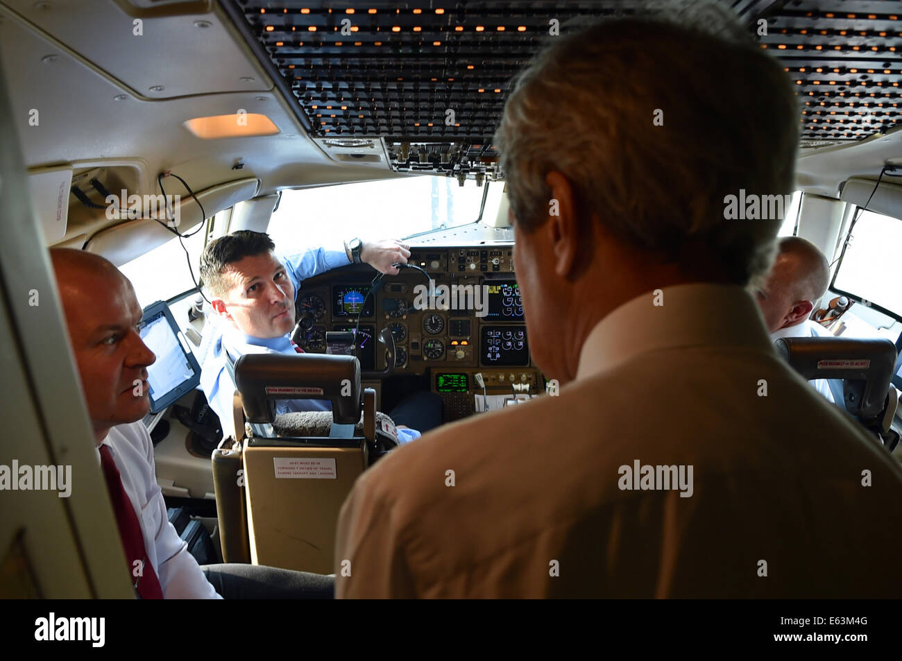 U.S. Secretary of State John Kerry chats with the flight crew of his U.S. Air Force jet at Andrews Air Force Base in suburban Washington on August 6, 2014, before they set out on an around-the-world trip that will take them to Afghanistan, Burma, Australi Stock Photo
