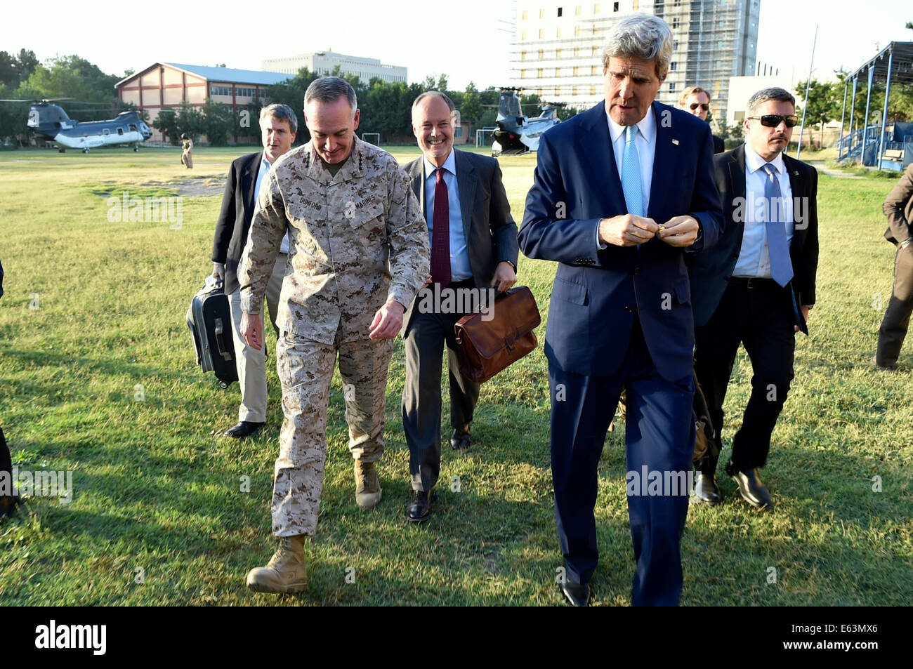 International Security Assistance Force (ISAF) Commander and Marine Corps General Joseph Dunford Jr. escorts U.S. Secretary of State John Kerry after he arrived in Kabul, Afghanistan, on August 7, 2014, for discussions about the country's ongoing presiden Stock Photo