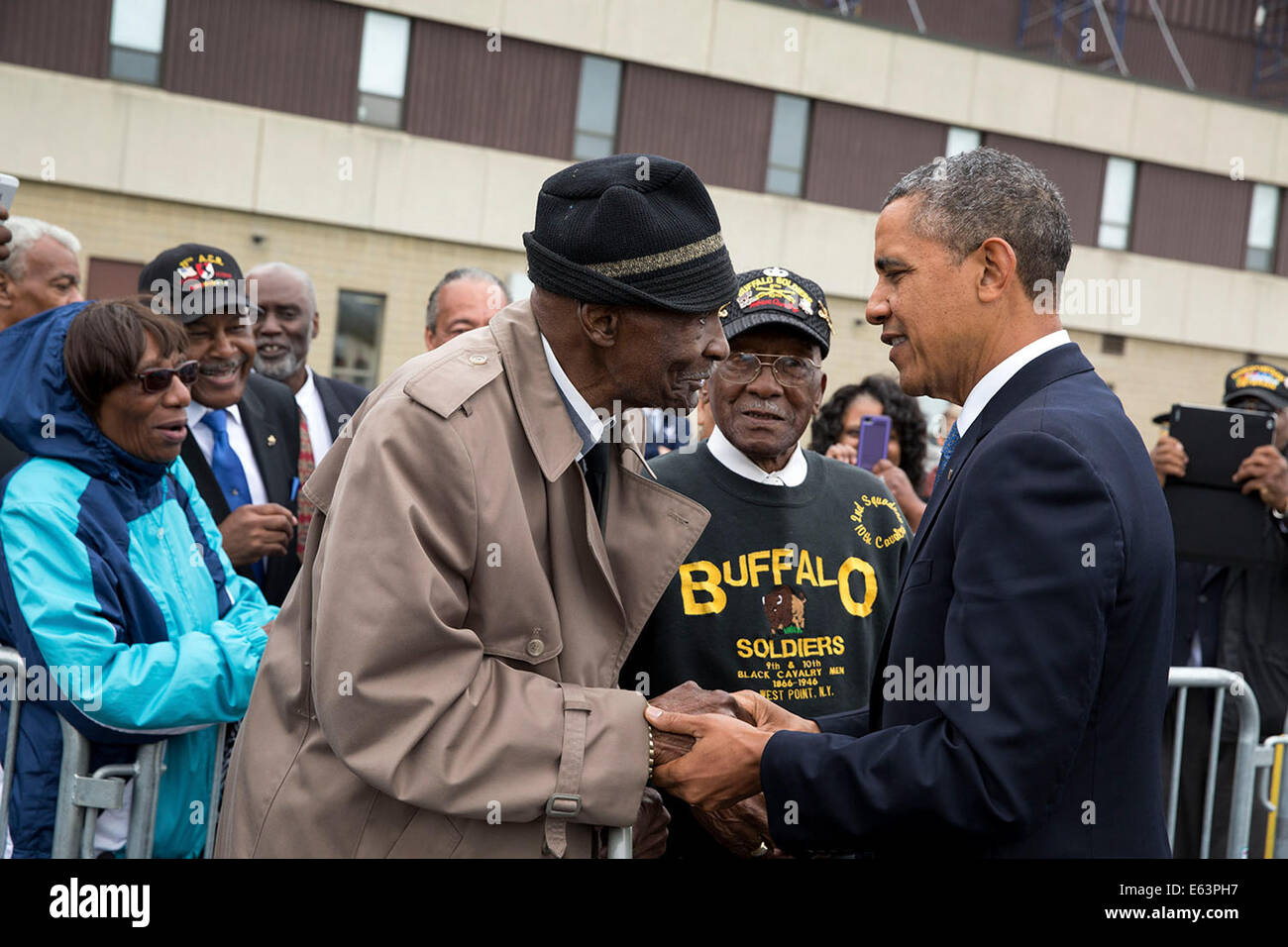 President Barack Obama greets 93-year-old Sanders H. Matthews, Sr., a retired U.S. Army Staff Sergeant and 'buffalo soldier,' at Stewart Air National Guard Base prior to departure from Newburgh, New York, May 28, 2014. Stock Photo