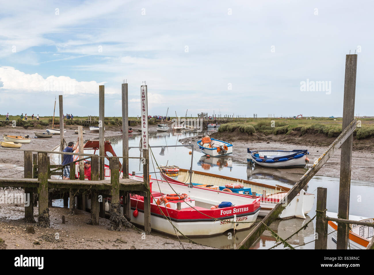 Boats at jetties at low tide at Morston, Norfolk in readiness for boat