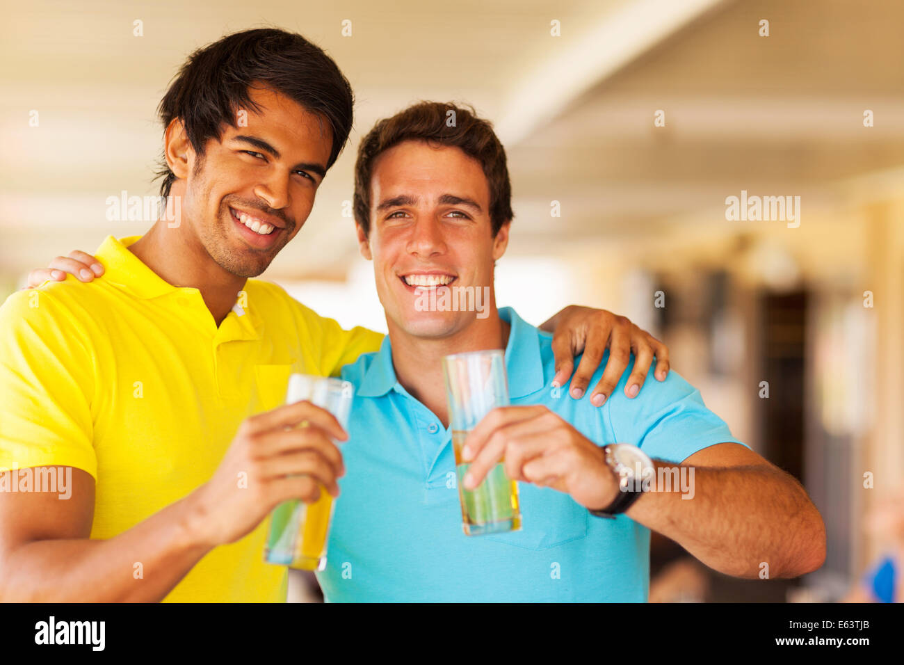 two happy friends drinking beer at the pub Stock Photo
