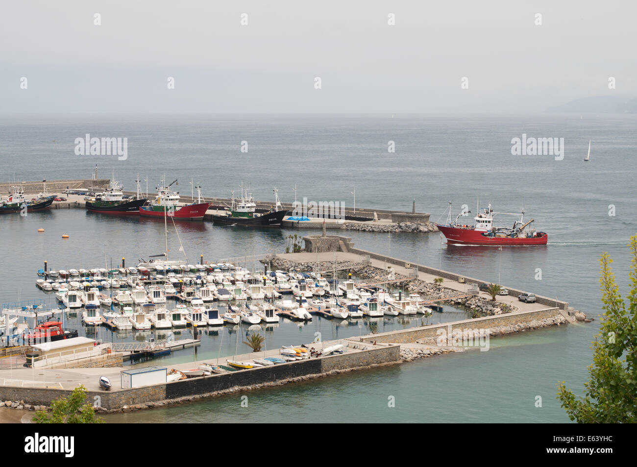 Fishing vessel entering the harbour at Getaria. Gipuzkoa, northern Spain, Europe Stock Photo